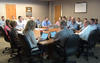 A group of people from BTES's Continuous Improvement Team conducts its Monday morning meeting.