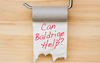 An empty toilet paper holder asking can Baldrige help?
