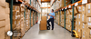 Warehouse Worker Checking Inventory Wearing Protective Mask