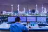 Engineering works with the tablet in the production control room.Control room of a steam Turbine,Generators of Oil refinery industry plant for monitor process, business and industry concept