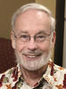 white haired man with glasses and a beard