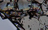 close up of a clear fractured glass like substance with some rainbow distortions