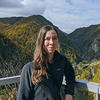 woman standing in front of green mountains