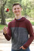 Steven Salisbury poses outside while tossing a Rubik's Cube into the air.