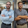 Side-by-side photos show twin brothers posing with arms crossed in lab or office settings.