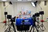 Cameras and equipment set up in the studio in front of a table