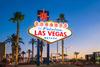 A neon sign that reads Welcome to Fabulous Las Vegas is lit up in neon in front of a sunset scene. 