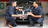 Two mechanics talking about a safe working environment.
