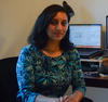 NIST researcher Nehika Mathur sits in front of her computer in her office. 
