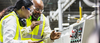 Multiracial workers in factory at machine control panel