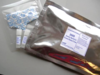 Photograph of SRM 2669 Arsenic Species in Frozen Human Urine, with vials and desiccant packs, and labeled mylar bag.