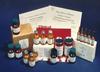 Photograph of several clinical Standard Reference Materials showing labeled boxes, bottles, vials, ampoules and printed certificates.