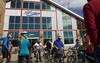 People gaithering in front of building getting ready to ride bicycles in the City of Fort Collins, Colorado.