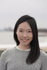 Xinyi Liu poses smiling outdoors for a head shot.