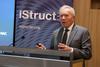 Glenn Bell speaks at a podium with an IStructE banner behind him. 
