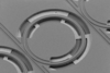 Scanning electron microscopy image showing electrodes placed underneath an air clad microresonator. 