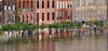 Floodwaters rise to the doorways of a row of historic brick buildings, one with a sign saying "Nashville."