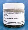 glass jar container with a white cap and white label that reads "Standard Reference Material 1947a great lakes fish tissue"