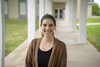 Stephanie Servetas poses smiling outdoors on the NIST Gaithersburg campus.