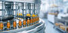 Medical ampoules line moving along a conveyer at a modern pharmaceutical plant as part of the drug manufacturing process.