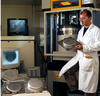 NIST researcher with metal stamping equipment